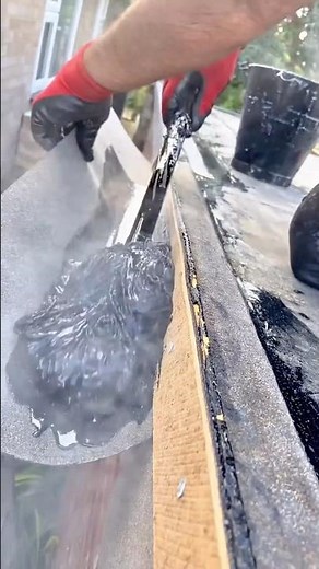 Applying protective sealant along the edge of the roof for waterproofing and durability