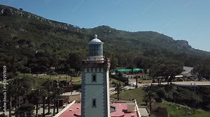 Cinematic 4K aerial of Cap Spartel lighthouse in Tangier, Morocco. Iconic maritime landmark at Africa's northwestern tip. Perfect for travel, history, and navigation-themed content.