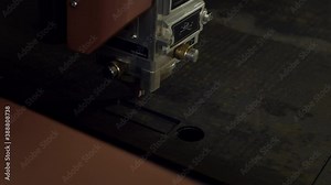 Laser cutting of metal. An industrial machine with a powerful luminous beam cuts a thick sheet of metal. Metalworking at the plant. CNC laser machine for cutting metal plate on industrial manufacture