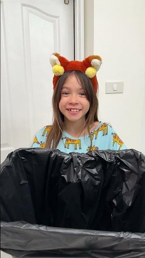 Kids learn to throw trash in a trash can