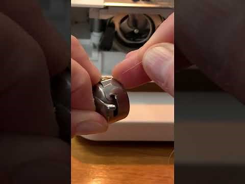 Omega sewing machine load bobbin