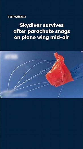 Skydiver's parachute snags on plane wing mid-air
