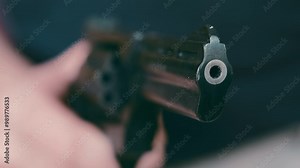 Dynamic Revolver Motion: Intense Barrel Close-up | Shifting Handgun in Macro Cinematography | Dramatic Firearm Movement with Blurred Background | Crime and Law Enforcement Action Footage