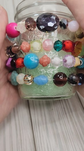 Create a fun DIY Candle holder out of a leftover mason jar and some beads! This easy and simple craft is the perfect way to use up extra beads in your bead stash. | Jesse James Beads