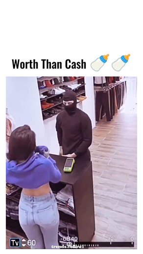 Viral Trending content on Instagram: "The video depicts a masked man entering a clothing store, approaching a female cashier from behind, and initiating hip-shaking movements that prompt her to turn and join in a light-hearted dance, implying a robbery attempt derailed by distraction. Shared by @BannedVids , an account specialising in provocative footage, the clip amassed over 2 million views and 18,000 likes in under 24 hours, with replies highlighting its comedic take on thwarted crime. Though