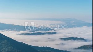 Time lapse the fog moves along the mountains in the morning and the sunlight in winter. Concepts of tourism and nature preservation.