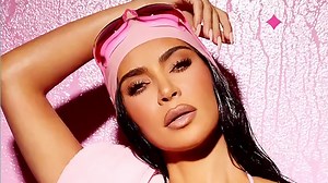 Kim almost busts out of teeny pink bikini as she flaunts oiled-up skin in pic