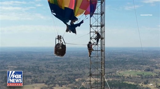 SKY-HIGH SNAG: Firefighters rescued two people after a hot air balloon crashed and became tangled nearly 900 feet up a cell tower in Texas. Crews climbed the structure, secured the balloon, and helped both individuals harness and safely rappel to the ground. | Fox News