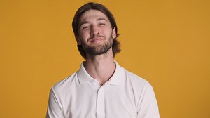Caucasian man waving at camera on yellow background. | Free Stock Video Footage