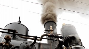 Old Industrial vintage retro steam engine locomotive driving on rails