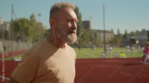 Old European man athlete sportsman running stadium city outside runner training pensioner bodybuilder muscular sport bodycare jogger physical activity elderly male workout endurance marathon racetrack