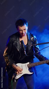 Vertical video Powerful female guitarist performs live with a thrash metal vibe, superstar giving her best for this performance. Grunge independent woman creating an unforgettable show. Camera B.