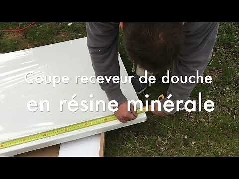 Coupe d'un receveur de douche, en résine minérale, avec une meuleuse et un disque diamant.