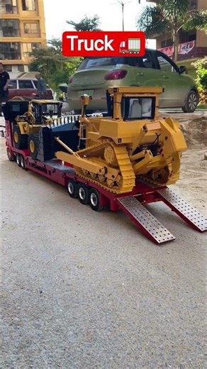 scale model remote-control hydraulic bulldozer being transported on an RC semi-trailer #truck #jcb