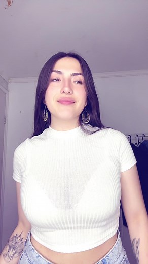 Young Woman in Crop Top Showcases Hand Gestures