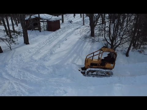 Old bulldozer plowing deep snow!