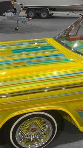 The 1962 Chevrolet Impala convertible lowrider sits shining at the car show like a true West Coast icon. Its long, smooth body lines are laid out perfectly, riding low with a flawless stance that shows off the classic lowrider style. The paint glows under the sun, reflecting deep colors and fine metal flake that catch every eye walking by. Chrome bumpers, wire wheels, and whitewall tires complete the look, giving it that timeless elegance. #1962impala #62impala #lowrider #lowriders #62chevyimpal