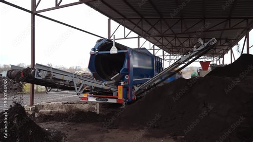 The equipment at the compost plant processes organic waste, and the ready-made stabilized organic fertilizer is sifted through a sieve