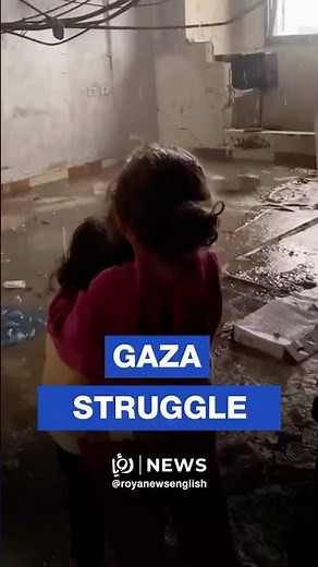 Gaza girl comforts her sister as rain floods their home