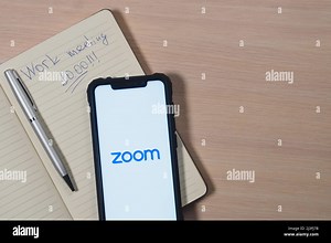 Zoom app logo on the screen smartphone. Zoom Video Communications is a company that provides remote conferencing services. Reminder of a meeting in da Stock Photo - Alamy