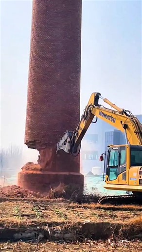 Real Engineerings | Engineering & Technology & Gadgets & DIY on Instagram: "Precision Demolition: Felling a Chimney Stack! 🧱🚜💨 ​Observe the calculated destruction of a towering brick industrial chimney! This technique, often called "mechanical felling," relies on physics and operator skill rather than explosives to bring down tall structures safely. ​The Engineering Behind the Fall This process mimics the mechanics of chopping down a tree: ​The Notch (Undercut): The operator uses the excavato