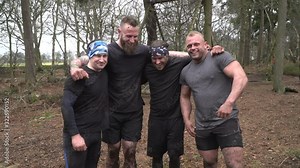 Group of male participants in a mud run / Obstacle course. These men are muddy. Team event. Slow motion - Stock Video Clip Footage