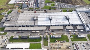 Overview of a large truck manufacturing facility showcasing assembly lines and logistic operations