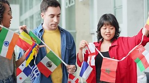 Multinational group with bunting flags. International exchange.