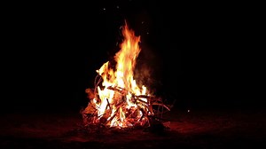Night Bonfire Burns in the Dark Forest Slow Motion. Flaming Campfire at Nighttime. Place for Bonfire. Fire Pit Outdoors, Wood on Fire, Flying Sparks and Smoke Static Shot