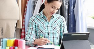 Woman designer stylist draws clothes sketch. Creative creation of fashion collection of clothes concept