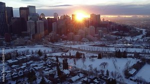 Flying through Calgary's downtown during a winter sunset with a drone