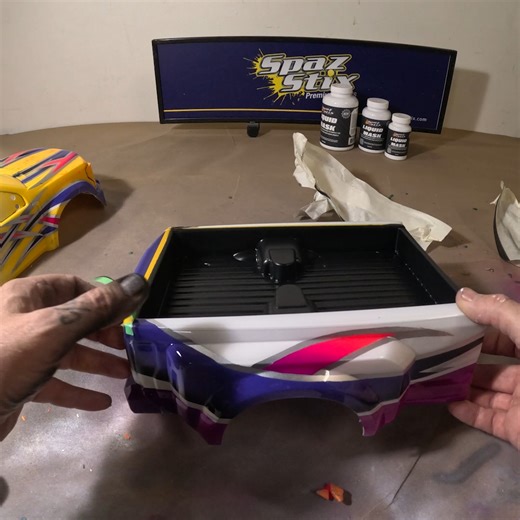 I wanted to make the bed on the CEN 450 to look like it had sprayed on bedliner. I cut the clear protective sheet around the bed and taped it off. Spaz Stix works fine on the outside of the body as well as the inside. As always I started with a light coat of our Surface Pre Prep spray for help with adhesion. Gave it a coat of Black, then after drying hit it with the No Shine Exterior Matte Clear Coat. Worked well and looks great in contrast to the shine on the body. Give it a try for those cool 