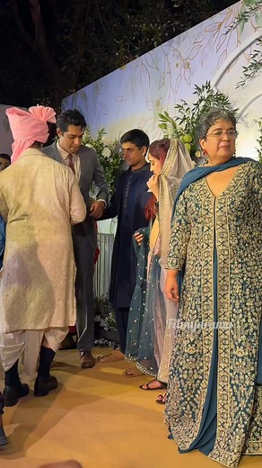 Aamir Khan expresses joy and warmth, sharing a heartfelt moment by kissing his ex-wife in celebration at his daughter's wedding. 💖👨‍👩‍👧‍👦 #AamirKhan #WeddingCelebration #FamilyLove | Filmydrama