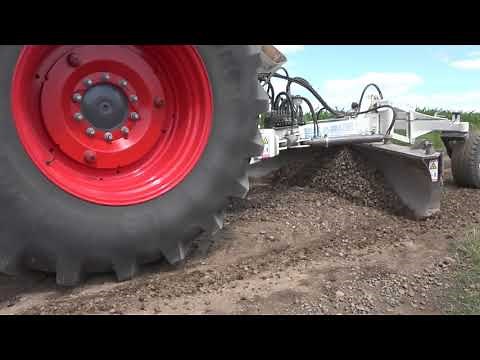 Grader for road construction with plate compactor