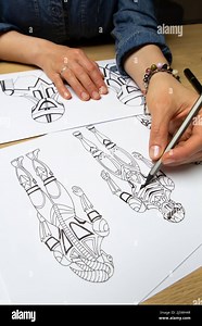Concept art. The artist draws sketches of cyborg robots on paper. Character design for a video game. Animation creation Stock Photo - Alamy
