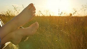 Woman legs out the windows in car . Conceptual freedom, travel and holidays image with copy space.