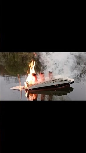 Cardboard ship burning and sinking
