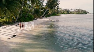 Aerial slow motion: Couple walking on tropical beach, Banyak Islands Sumatra Indonesia away from it all, caribbean sea white sand beach travel destination for diving snorkeling