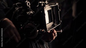 Operator adjusting camera before filming. Shooting with red camera. Close-up