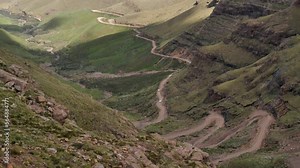 Tourist trucks finish steep switchback segment of Sani Pass, S Africa