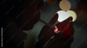 Woman with Curly Hair lighting up a Cigarette Outside at Night