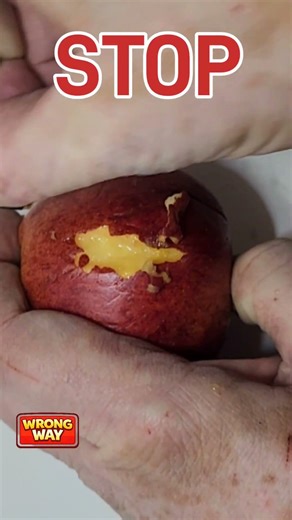 Paper binder clip peeling an apple
