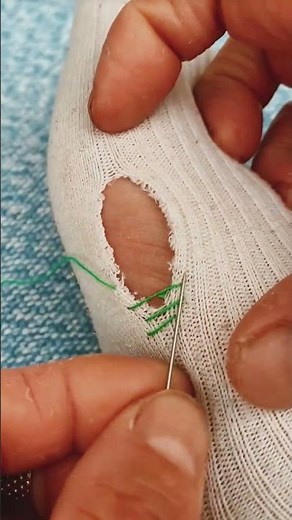 Sew a tear in a sock with a needle and thread