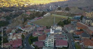 Aerial view of cable cars traveling over a football field in La Paz, Bolivia.