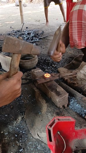 Watch how a skilled blacksmith hand-forges nails from old iron by hammering it into shape."