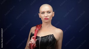 Very beautiful bald woman in a black leather corset with a whip and handcuffs on a dark background. copy space