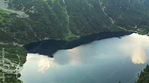 Flying High Above the Water and a Sea of Fog at Sunrise over the mountains. Morskie Oko lake in Tatra Mountains. Flying over the clouds. Lush Scenery and Magnificent Mountain Range With two lakes
