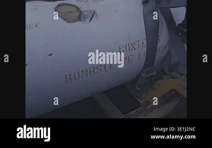 INDIAN OCEAN - 1980 - A truck towing an LTV A-7 Corsair II with stacks of missiles in the foreground. A crewman wiping the cockpit windows of a fighter aircraft Stock Video Footage - Alamy