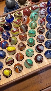Here’s a quick (17 seconds) close up view of my Akro Oxblood collection. Tray made by Charlie Detjen. Arranged by type. A fun, although somewhat difficult group to put together. All marbles are in mint condition. (Edit: Top two rows are all 3/4” or very close. Third row mostly 11/16”, then others coming down are standard sized marbles.) | Mike's Marbles & Collectibles