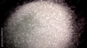 Sugar close-up. Granulated sugar on a black tray. White death. Diabetes
